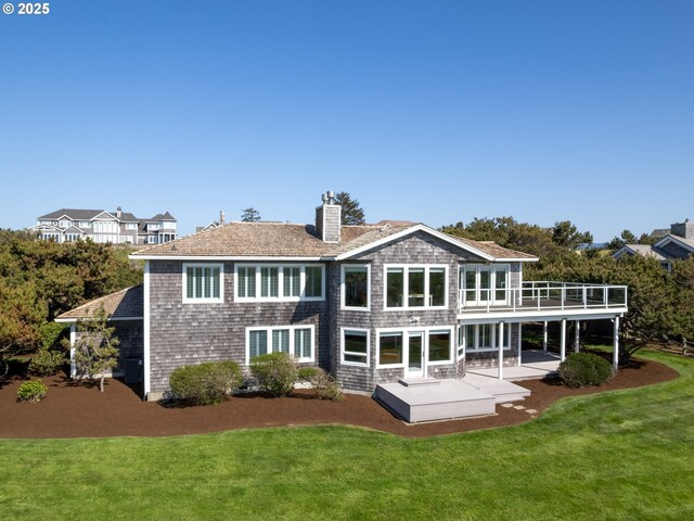 back of property featuring a chimney, a patio area, and a yard