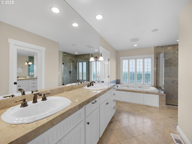 bathroom featuring a shower stall, a garden tub, double vanity, and recessed lighting