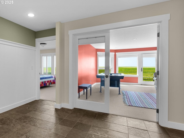 doorway with stone tile flooring, baseboards, recessed lighting, and french doors