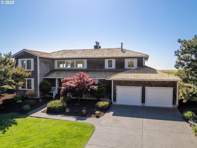 view of front of home featuring driveway, an attached garage, a chimney, and a front lawn