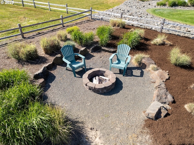 view of yard featuring an outdoor fire pit, fence, and a patio