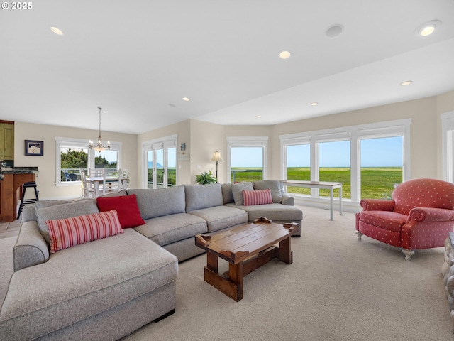 living area with light colored carpet, recessed lighting, and a chandelier