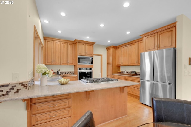 2038 Morning View Dr, Eugene, OR 97405 - kitchen featuring stainless steel appliances, a peninsula, recessed lighting, a breakfast bar area, and light wood-style flooring