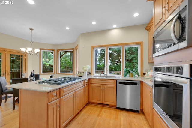 2038 Morning View Dr, Eugene, OR 97405 - kitchen featuring stainless steel appliances, light wood-type flooring, a chandelier, light stone countertops, and recessed lighting