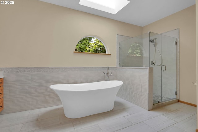 2038 Morning View Dr, Eugene, OR 97405 - bathroom with a skylight, vanity, a freestanding tub, a stall shower, and tile walls