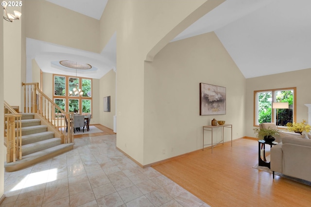 2038 Morning View Dr, Eugene, OR 97405 - foyer entrance featuring a chandelier, high vaulted ceiling, arched walkways, and stairs
