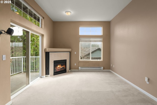 unfurnished living room featuring a baseboard heating unit, a tile fireplace, and light carpet