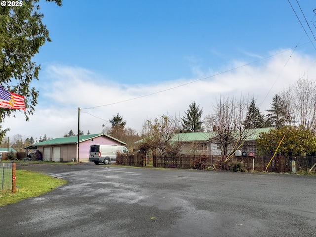 view of front of property with a garage and fence