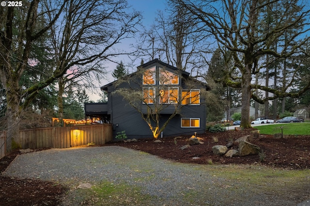 exterior space with gravel driveway and fence