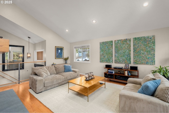 living area featuring recessed lighting, vaulted ceiling, and wood finished floors