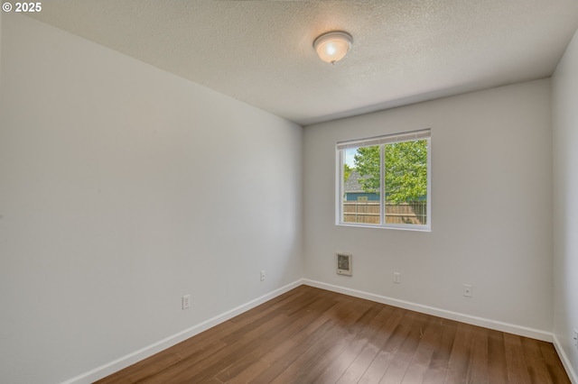 13712 NE 91st St, Vancouver, WA 98682 - empty room featuring dark wood-style flooring and a textured ceiling