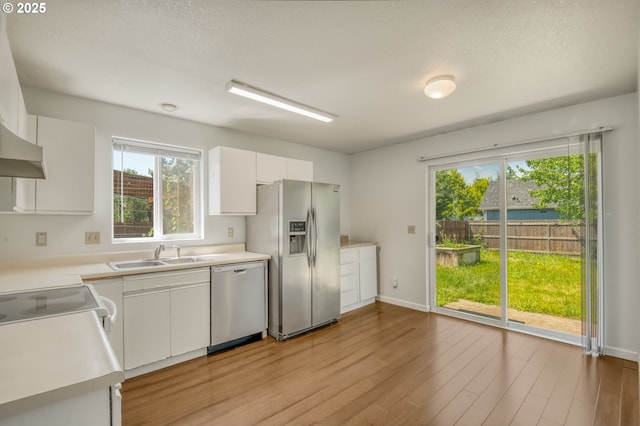 13712 NE 91st St, Vancouver, WA 98682 - kitchen with appliances with stainless steel finishes, light wood finished floors, light countertops, and white cabinetry