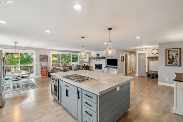 kitchen with stainless steel appliances, recessed lighting, baseboards, and open floor plan