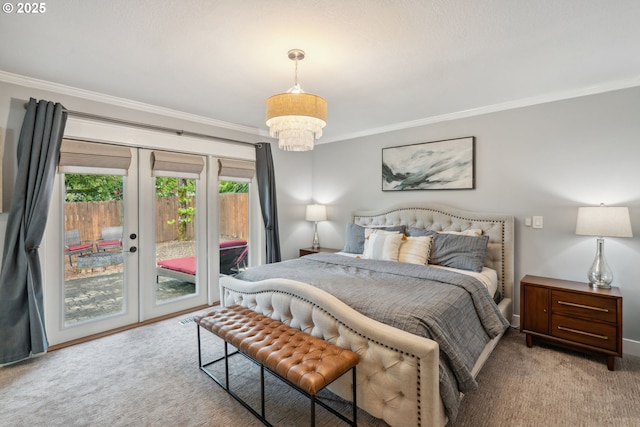 bedroom featuring ornamental molding, access to outside, carpet flooring, french doors, and a chandelier