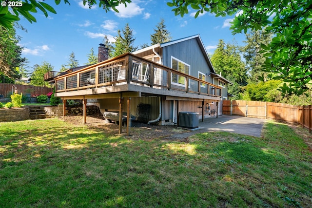 rear view of property featuring a deck, cooling unit, and a chimney