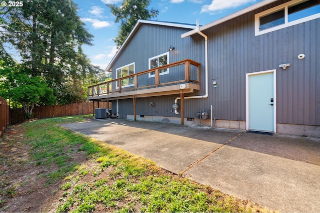 back of property featuring fence, central AC, and a patio