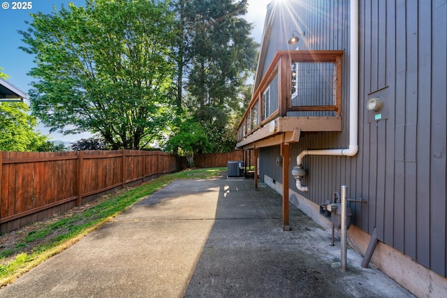 view of home's exterior featuring a fenced backyard, central AC unit, and a patio area