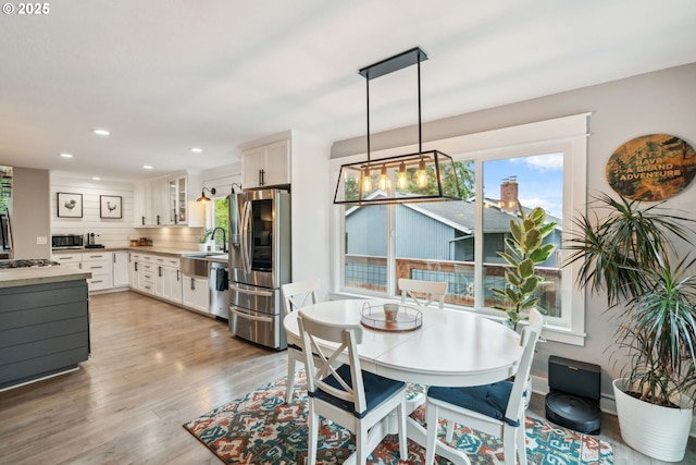 dining room with light wood-style floors and recessed lighting