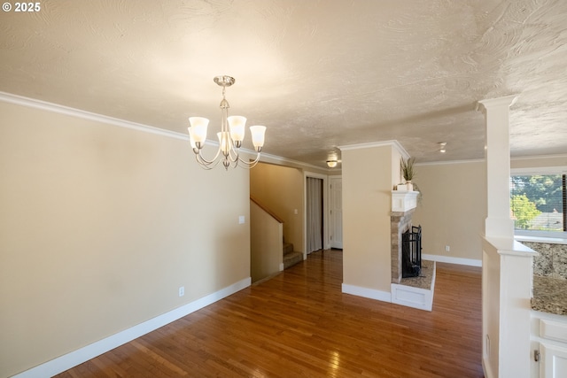 1221 SW Maple St, Dallas, OR 97338 - unfurnished living room featuring wood finished floors, a chandelier, ornamental molding, stairs, and baseboards