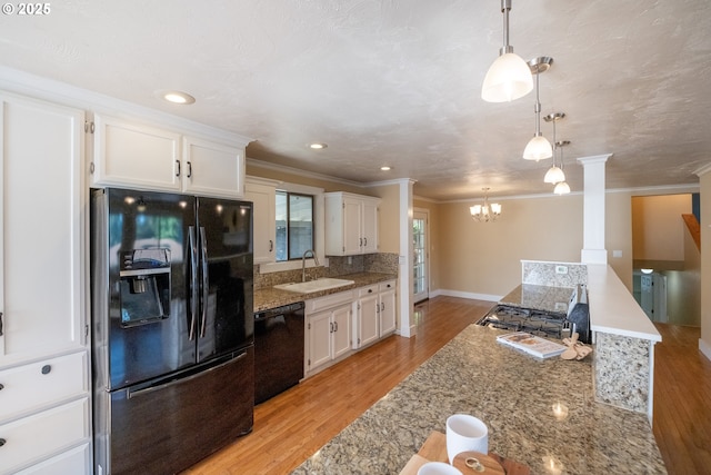 1221 SW Maple St, Dallas, OR 97338 - kitchen with black appliances, a sink, crown molding, white cabinetry, and light wood-style floors