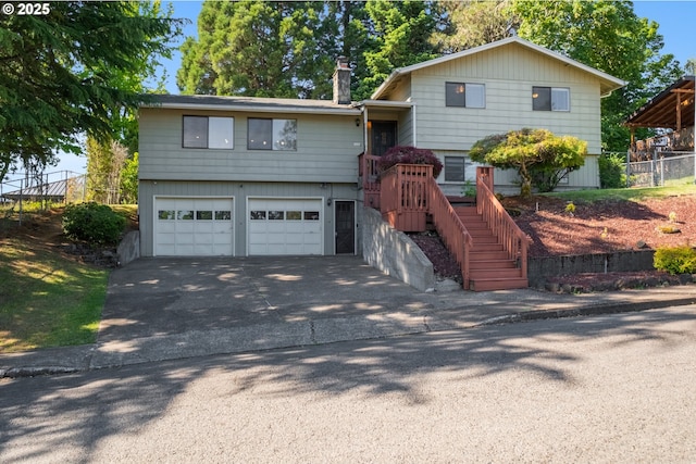 1221 SW Maple St, Dallas, OR 97338 - split level home with a garage, driveway, and a chimney