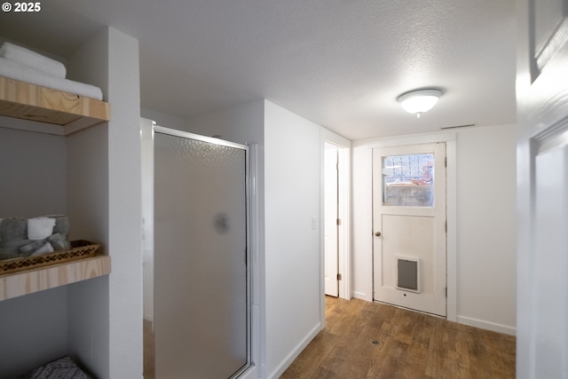 1221 SW Maple St, Dallas, OR 97338 - bathroom with wood finished floors, a stall shower, and baseboards