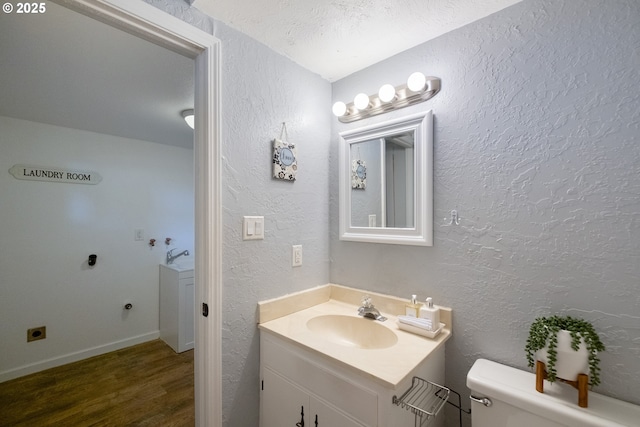 1221 SW Maple St, Dallas, OR 97338 - bathroom with toilet, wood finished floors, vanity, and a textured wall