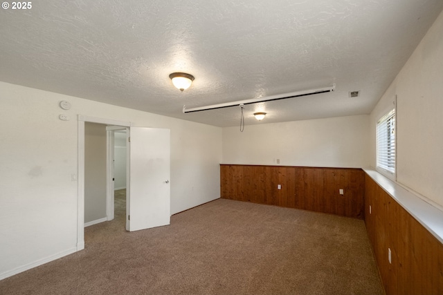 1221 SW Maple St, Dallas, OR 97338 - unfurnished room with carpet, a textured ceiling, wooden walls, a wainscoted wall, and a smoke detector