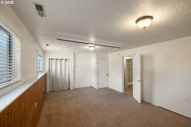 1221 SW Maple St, Dallas, OR 97338 - unfurnished bedroom with light carpet and a textured ceiling