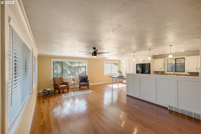 1221 SW Maple St, Dallas, OR 97338 - living room featuring ornamental molding, a ceiling fan, light wood-type flooring, and baseboards