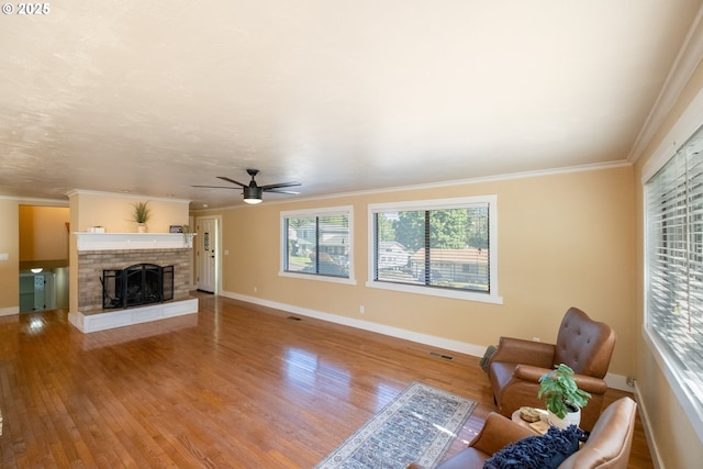 1221 SW Maple St, Dallas, OR 97338 - living area featuring ceiling fan, wood finished floors, baseboards, a brick fireplace, and ornamental molding
