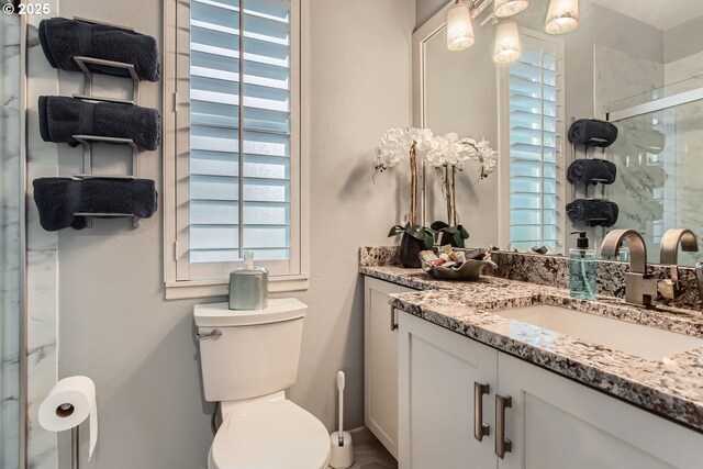 bedroom featuring ensuite bathroom and dark hardwood / wood-style floors