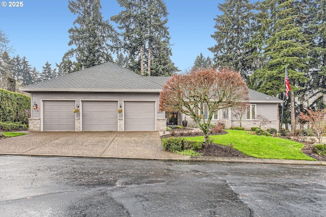 view of front of home featuring a front yard and a garage