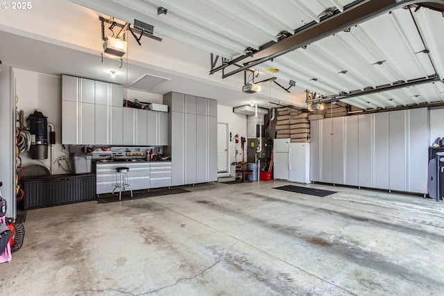 garage with a garage door opener and white fridge