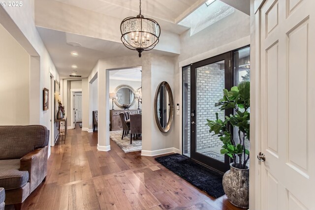 entryway featuring an inviting chandelier and hardwood / wood-style flooring