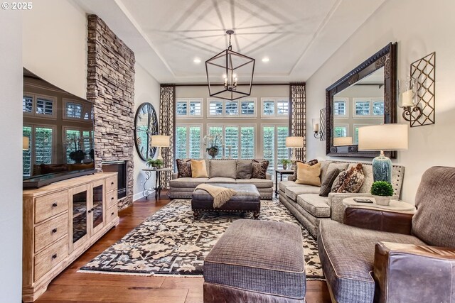 living room with a notable chandelier and dark hardwood / wood-style floors