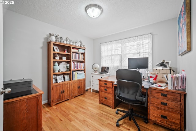 office featuring a textured ceiling and light hardwood / wood-style floors