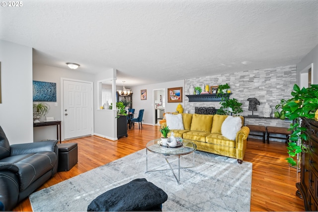 living room with hardwood / wood-style floors, a chandelier, and a textured ceiling