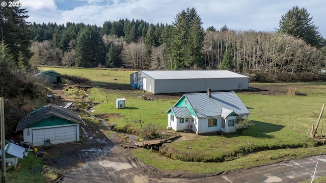 drone / aerial view featuring a rural view and a view of trees