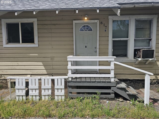 617 SW 3rd St, Pendleton, OR 97801 - property entrance with a shingled roof and cooling unit