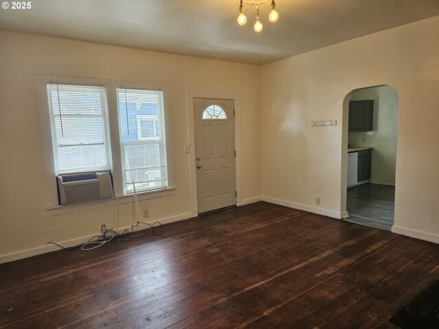617 SW 3rd St, Pendleton, OR 97801 - foyer entrance featuring arched walkways, cooling unit, dark wood-type flooring, and baseboards
