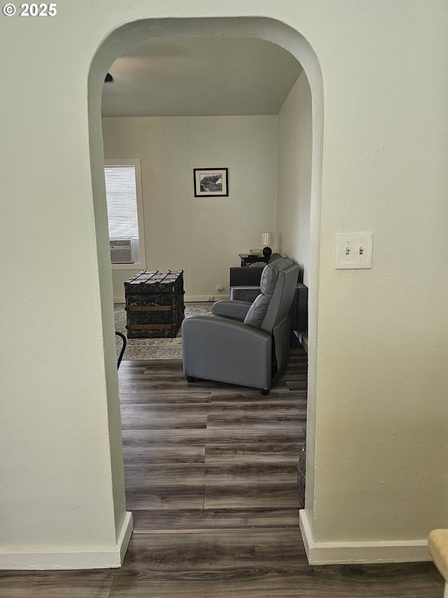 617 SW 3rd St, Pendleton, OR 97801 - living area with arched walkways, dark wood finished floors, cooling unit, and baseboards