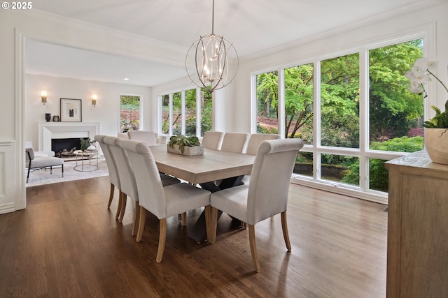 6230 SW Patton Rd, Portland, OR 97221 - dining space featuring dark wood-type flooring, a chandelier, ornamental molding, and a fireplace