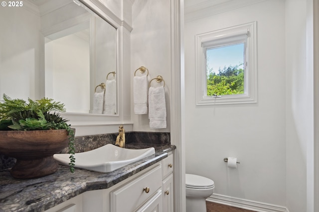 6230 SW Patton Rd, Portland, OR 97221 - bathroom featuring toilet, vanity, ornamental molding, baseboards, and wood finished floors