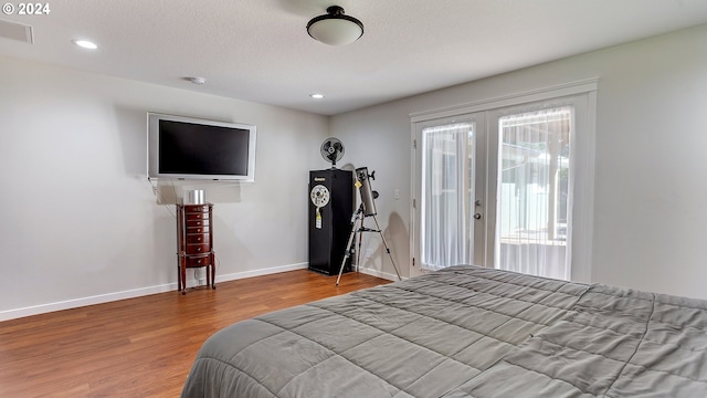 bedroom featuring french doors, visible vents, wood finished floors, access to outside, and recessed lighting