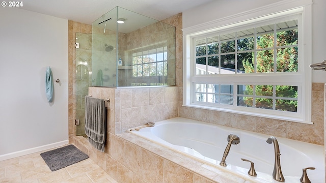 full bath with a garden tub and a tile shower