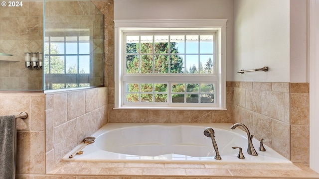 full bath with plenty of natural light and a bath