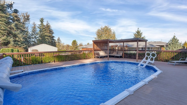 view of pool with a wooden deck and an outdoor hangout area
