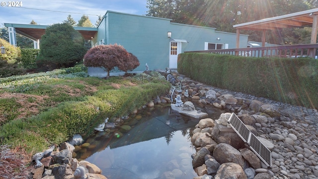view of side of property with fence and concrete block siding