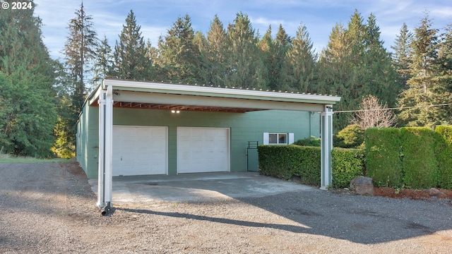 garage with a detached garage and driveway